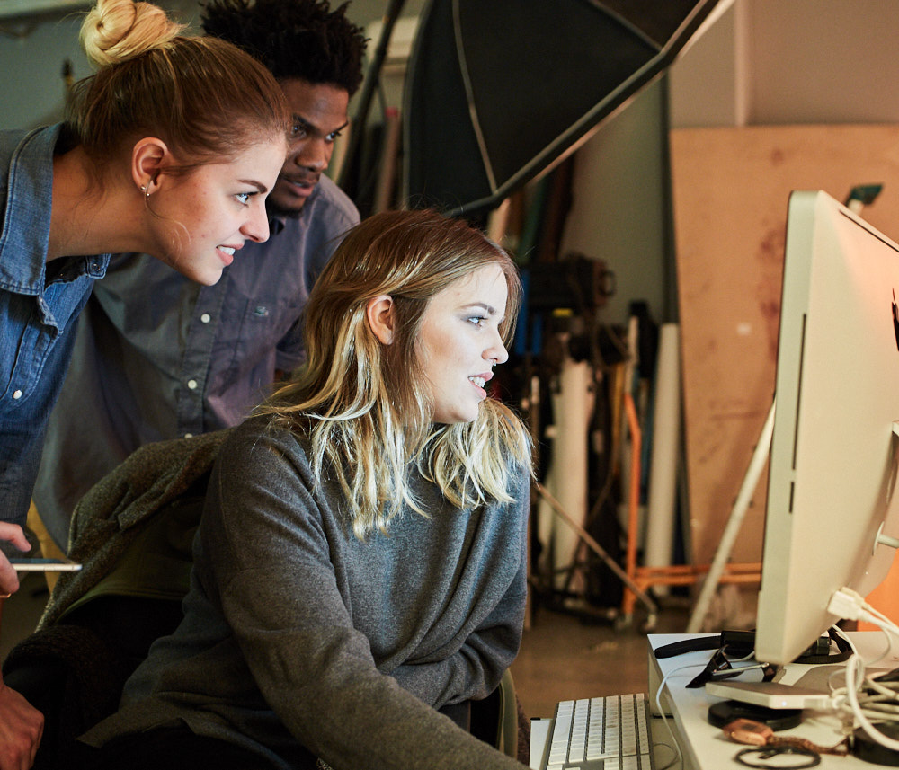 Des étudiants regardant un ordinateur dans un studio photo ETPA