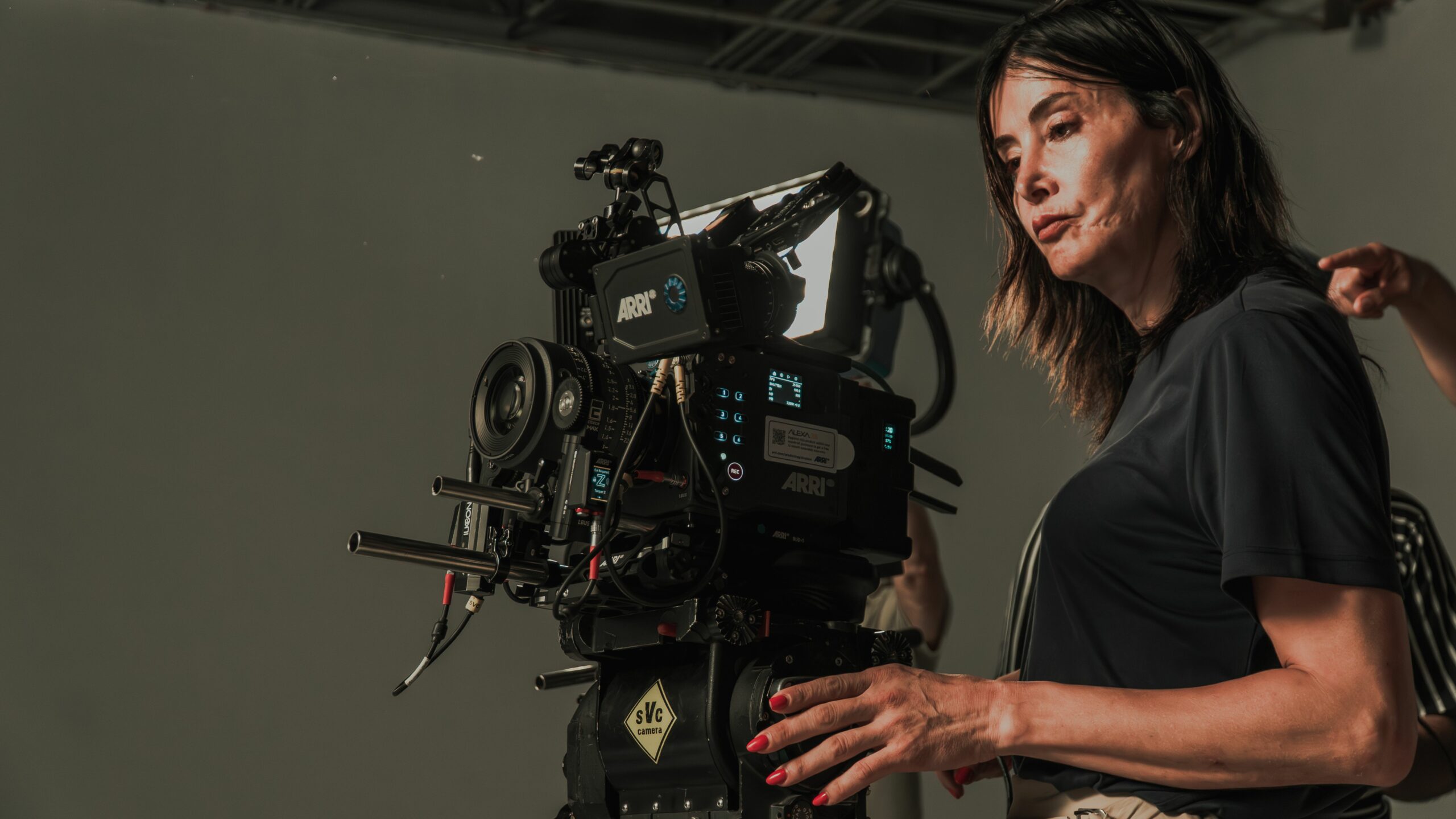 Une directrice de la photographie utilise une caméra professionnelle sur un plateau de tournage